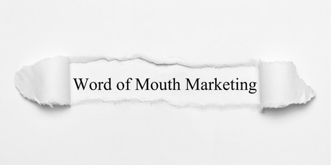 Word of Mouth Marketing on white torn paper