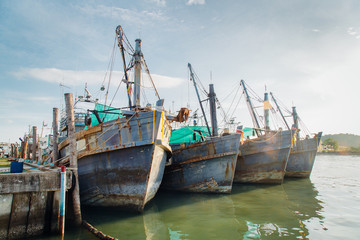 Fototapeta na wymiar Fishing boats in a harbour and a blue sky.