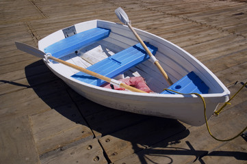Fototapeta premium Blue and White Dinghy on a Dock