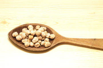 Chickpeas on wooden spoon