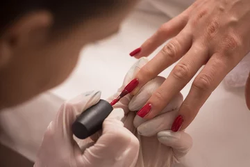 Zelfklevend Fotobehang Manicure Woman hands receiving a manicure