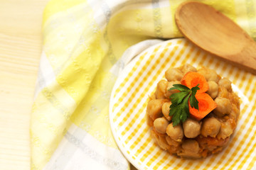 Chickpeas cooked on wooden table plate