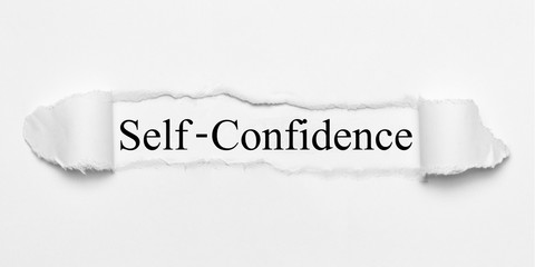 Self-Confidence on white torn paper