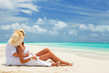 Happy honeymoon vacation at Paradise. Couple relax on the white sand of beach. Happy sea lifestyle. Young family, man and woman rest on the beach of ocean. Couple in love travel to island. Love travel - 140186189