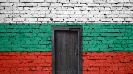 Bulgaria flag on brick wall. Closed door in a wall