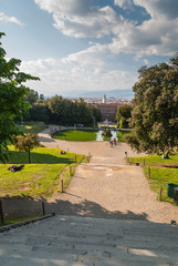 Florence cityscape viewed from Tuscan garden with dramatic sky and green fountain in the center