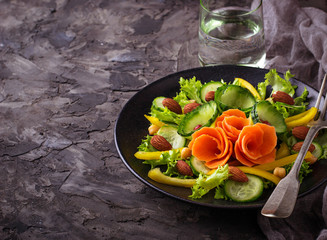 Vegetable salad with carrot, cucumber, pepper, almond and chick-pea