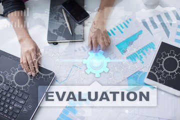 Woman is working with documents, tablet pc and notebook and selecting evaluation.