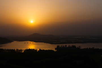 Fototapeta na wymiar High Angle View of Dal Lake Landscape at Evening Sunset in Srinagar, Kashmir, India