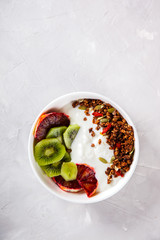 Granola,yogurt with kiwi and red oranges.Breakfast useful.Concept of Healthy Food.Copy space for Text. selective focus.