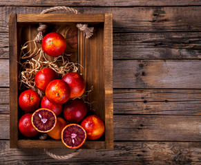 Blood Orange Citrus in a Wooden Box on Vintage Background.Toned image.Vintage style.Concept of Healthy Food.Copy space for Text.Vegetarian. selective focus.