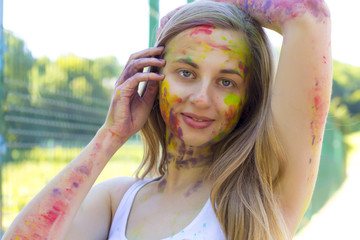 Attractive blonde woman in the park at Holi festival