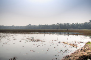 Naklejka premium The big lake next to the Tomb Mosque of Khan Jahan Ali in Bagerhatat the edge of the Sundarbans in Bangladesh 