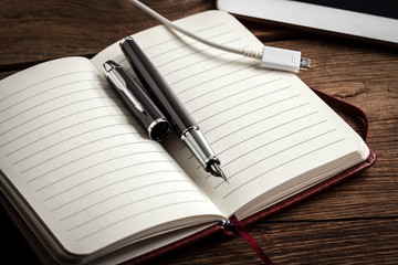 Blank notebook and ink pen.