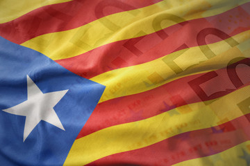 colorful waving national flag of catalonia on a euro money banknotes background.