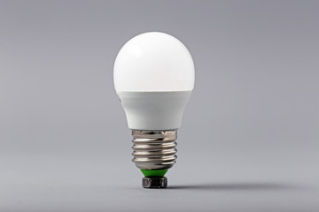 Electric light bulb on a gray background