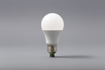 Electric light bulb on a gray background