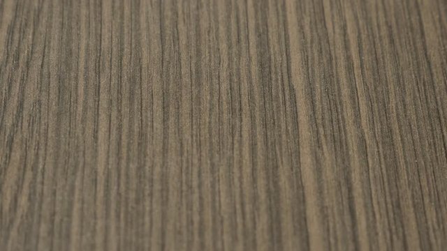 Wood grain oak tree artificial surface slow tilt 4K 2160p 30fps UltraHD footage - Wenge texture of furniture material close-up 3840X2160 UHD tilting video 