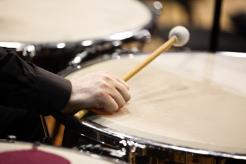 Obraz na płótnie Canvas The hand of a musician playing on a timpani closeup
