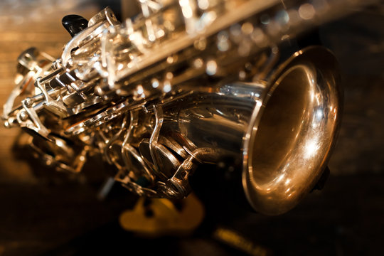 Fragment of a saxophone closeup in dark colors