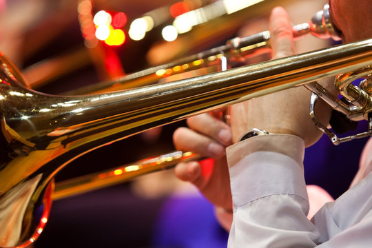  Hands musician playing the trombone in the orchestra closeup