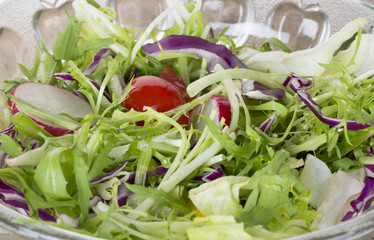Pouring olive oil in the salad over a spoon , Healthy food lifestyle. Fresh salad with oil