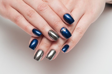 Festive manicure on long square blue nails with melate, mirror and crystals