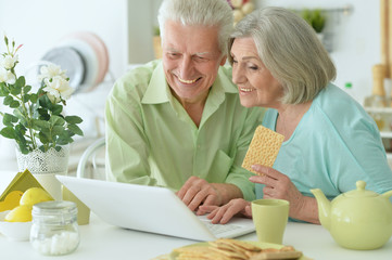 Beautiful elderly couple having breakfast 