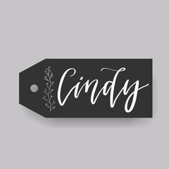 Common female first name Cindy on a tag. Hand drawn calligraphy. Wedding typography element.