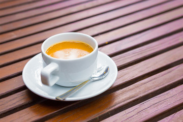 Cup of coffee on wood table background with copy space for any design. Coffee Mug on Wooden Table