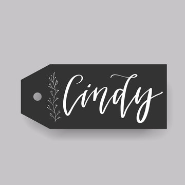 Common female first name Cindy on a tag. Hand drawn calligraphy. Wedding typography element.