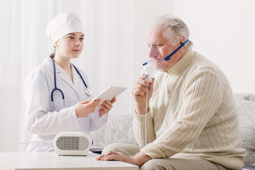 doctor does inhalation elderly man