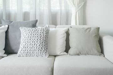 Light gray sofa set with pillows in modern interior living room