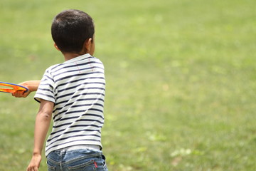 Japanese boy playing flying disc (first grade at elementary school)