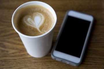 Fototapeta na wymiar a cup of coffee and the phone