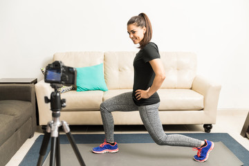 Fototapeta na wymiar Fitness blogger demonstrating an exercise