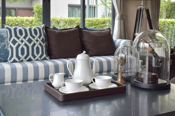 decorative tray of tea cup on wooden table in luxury living room interior