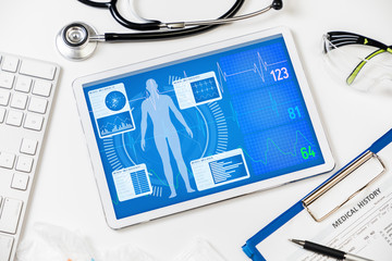 vital signs in tablet screen, medical technology concept, various medical equipments