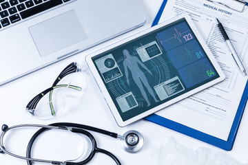 vital signs in tablet screen, medical technology concept, various medical equipments