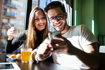 Beautiful young couple having a break time in the coffee.