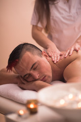 Obraz na płótnie Canvas young man having a back massage
