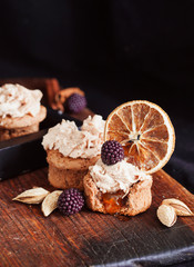 almond and orange cupcake with fresh blackberry