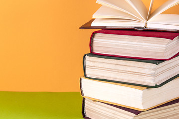 Open book, hardback bookson bright colorful background.