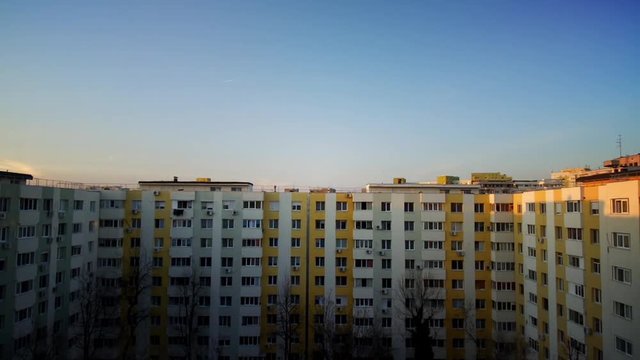 Time lapse of some flats in a block, with lights coming on and off.