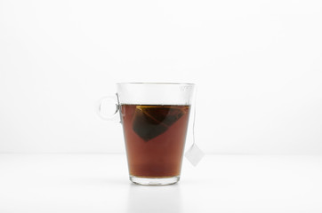 Glass Of Hot Tasty Back Tea On White Background