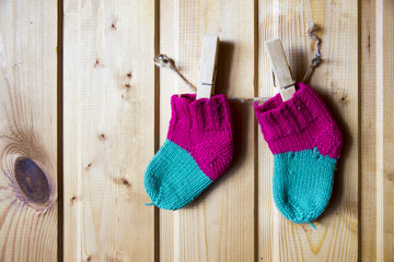 Baby socks hang on clothespins