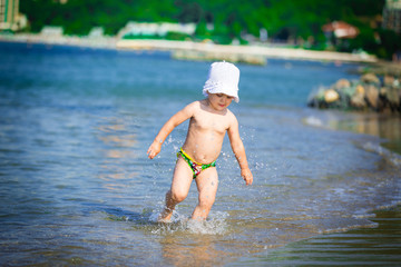Girl runs along the beach seashore summer