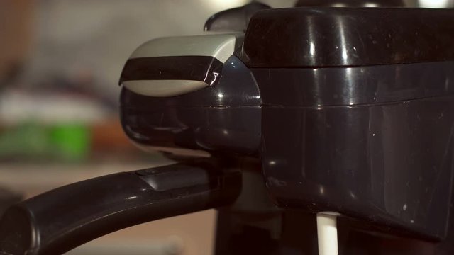 Making coffee in a coffee machine at home, close-up. High resolution