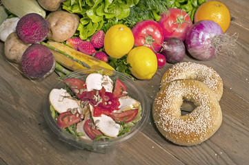 bagels,salad,fruits and vegetables on table

