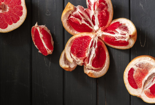 Fresh grapefruits on dark wooden background